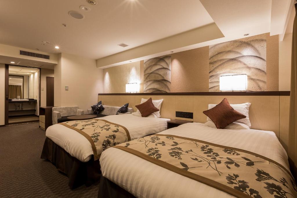 Postel nebo postele na pokoji v ubytování Matsue Excel Hotel Tokyu
