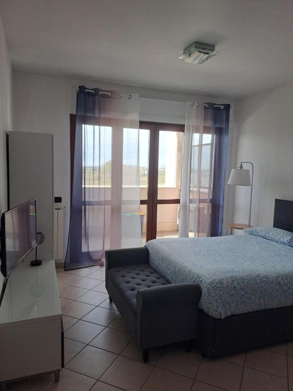 a bedroom with a bed and a couch at Locazione Turistica Gloria in Fiumicino Airport