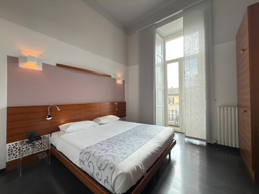 Postel nebo postele na pokoji v ubytování Hotel Europa Varese