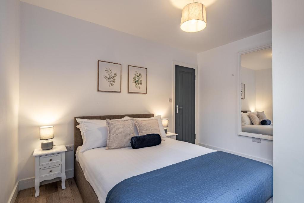 a bedroom with a large bed and a mirror at Crown Street Apartments in Wellington