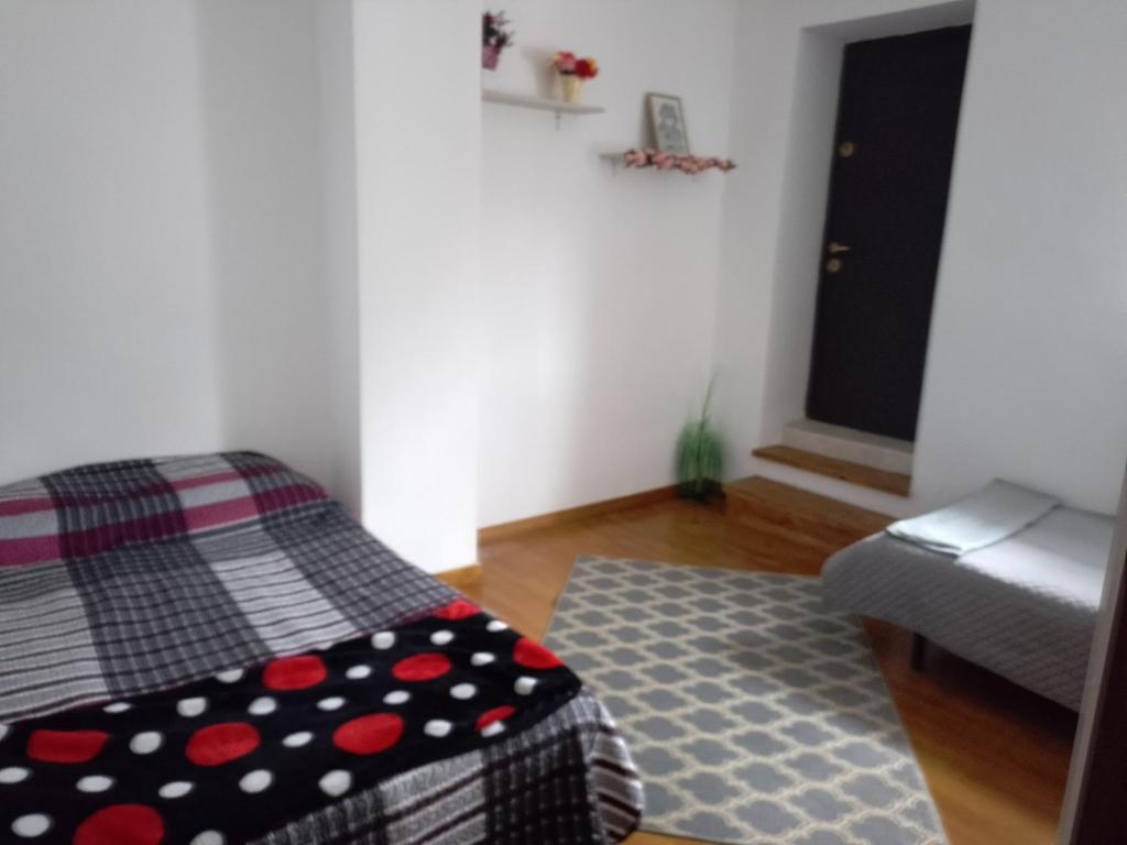 Cette petite chambre comprend un lit et un tapis. dans l'établissement Garsoniera, à Ocniţa