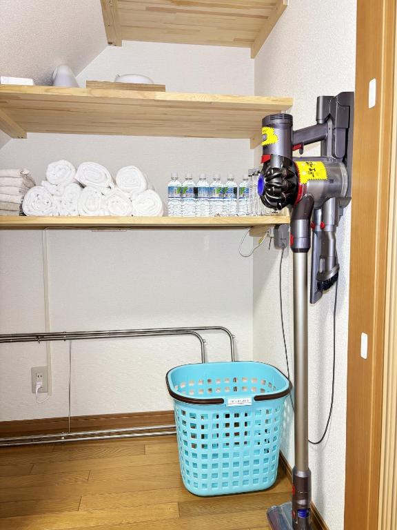 a blow dryer in a room with a basket at 桜の宿-大阪城Osaka castle-105m2 private-5Way access-KIX USJ 難波心斎橋 Direct in Osaka