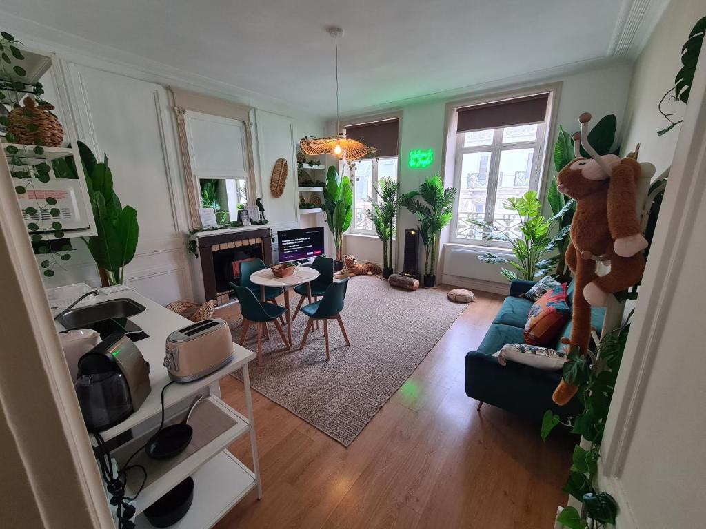 un salon avec un canapé et une table dans l'établissement Jungle Évasion - Détente & Comfort, à Boulogne-sur-Mer