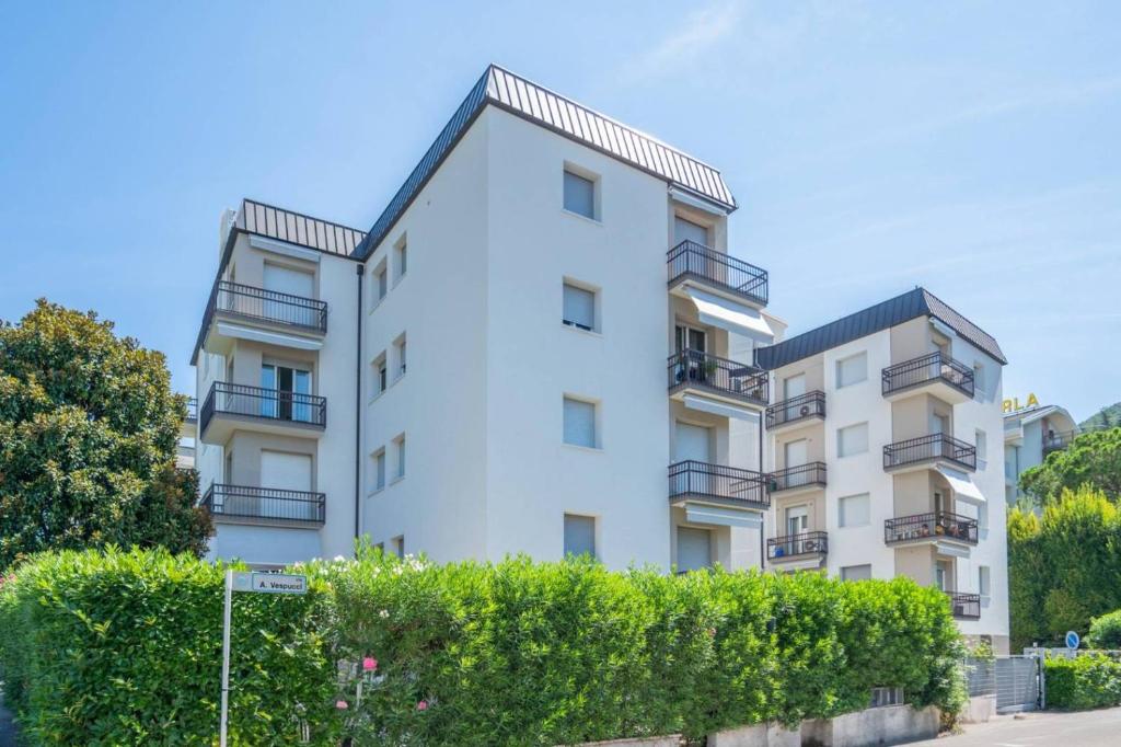an apartment building with balconies and bushes at REGINA GARDESANA Lakeshore in Garda