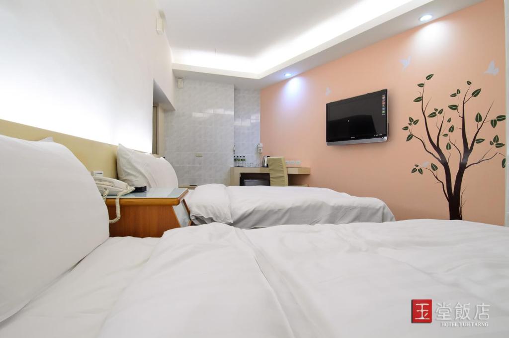 Postel nebo postele na pokoji v ubytování Yuh-Tarng Hotel
