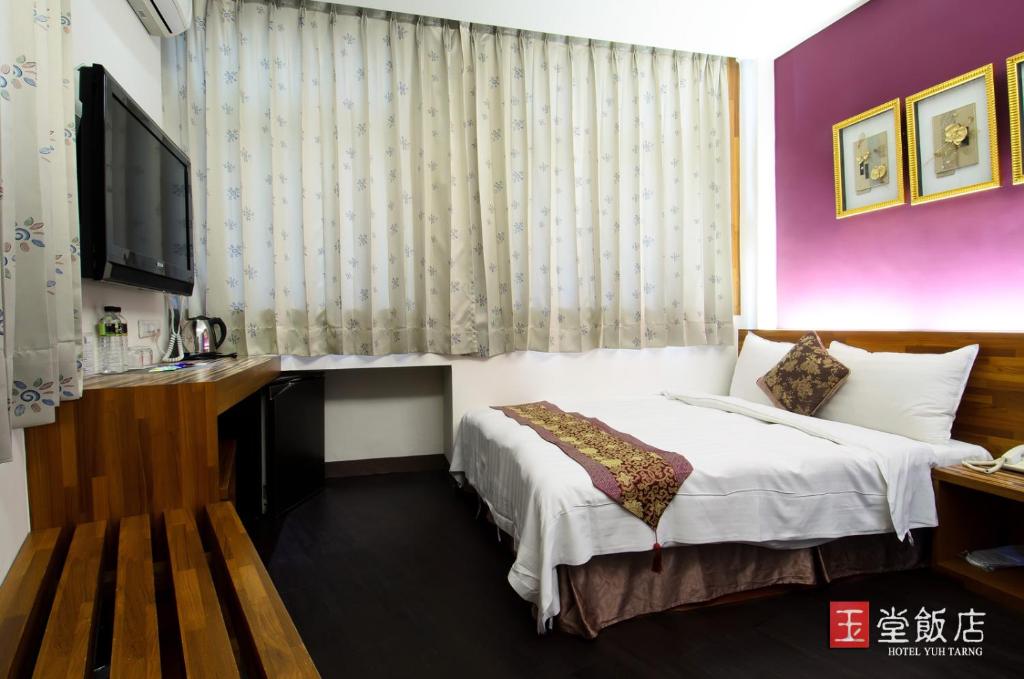 Postel nebo postele na pokoji v ubytování Yuh-Tarng Hotel