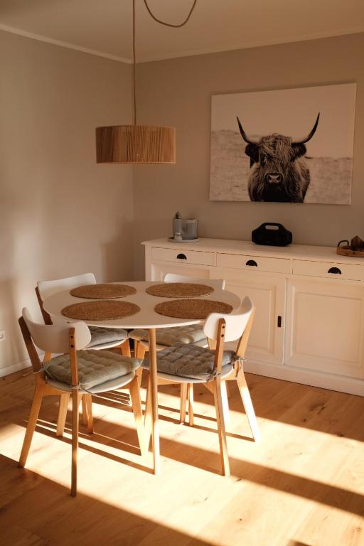 a dining room with a table and two chairs at FEWO Silberberg in Dornstetten