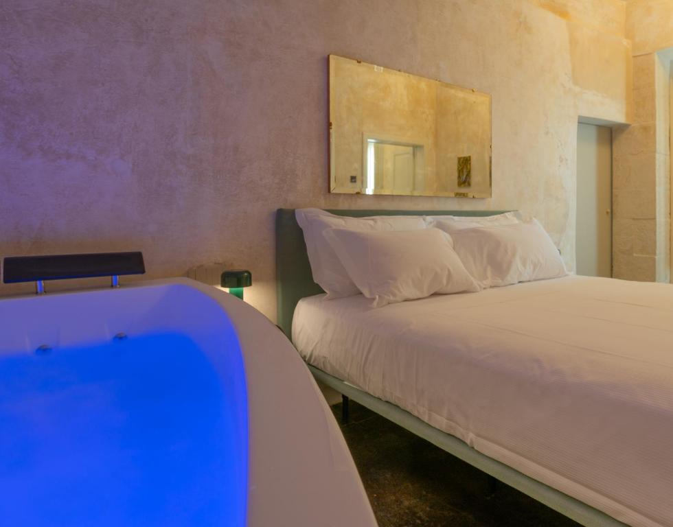 Postel nebo postele na pokoji v ubytování P43 Sicilian Suites