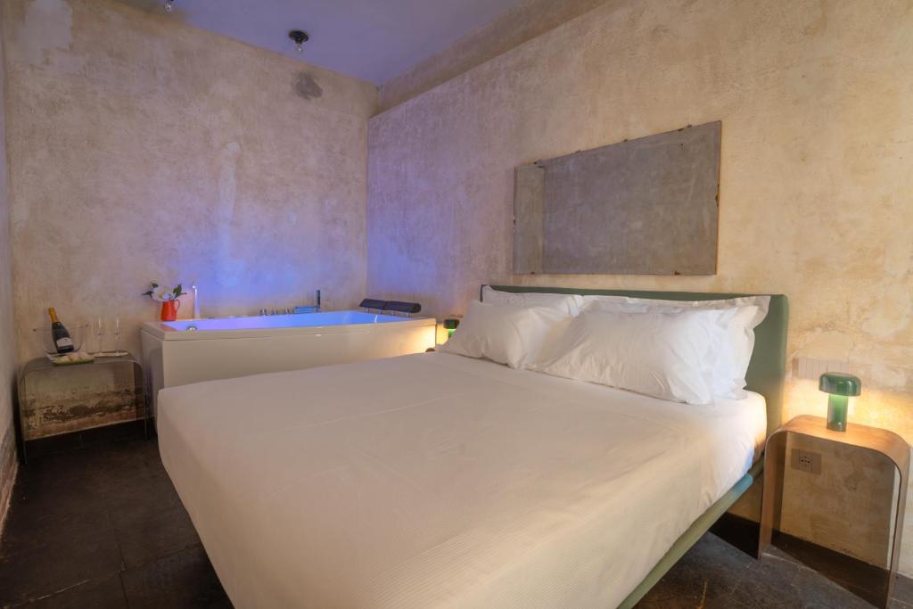 Postel nebo postele na pokoji v ubytování P43 Sicilian Suites