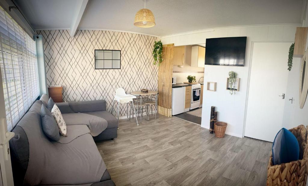 a living room with a couch and a kitchen at Great Yarmouth Chalet in Great Yarmouth