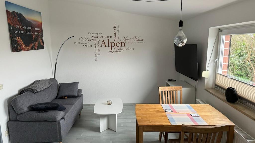 a living room with a couch and a table at Moderne Industriewohnung in Everswinkel