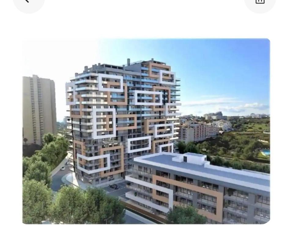 a view of a tall building in a city at Rocha T Apartments in Portimão