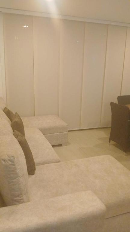 a living room with a couch and a chair at Ciudad Cristales in Villeta