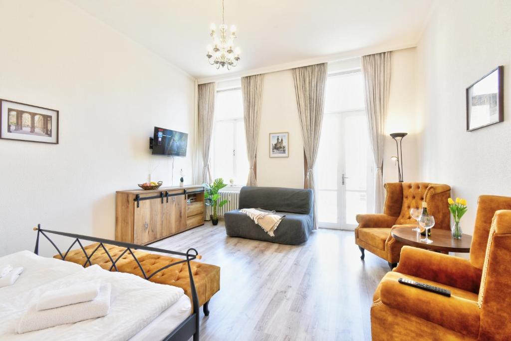 a living room with a bed and a couch at Karlsbad Holiday in Karlovy Vary