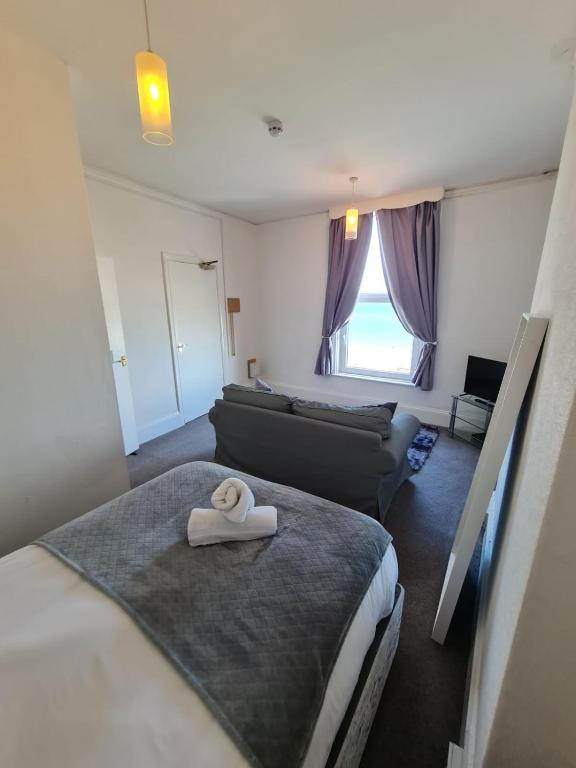 a hotel room with two beds and a couch at Farina No7, Sea view studio sleeping 2 guests in Bridlington