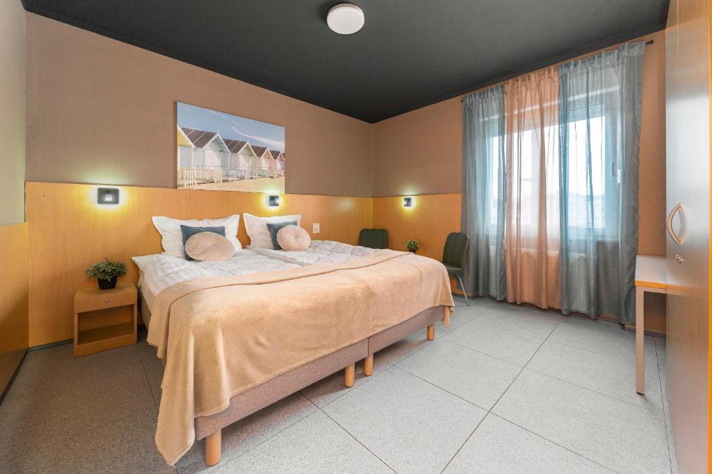 a bedroom with a large bed with yellow walls at PREMIUM B&B Nova Gorica, Self Check-In with code access in Nova Gorica