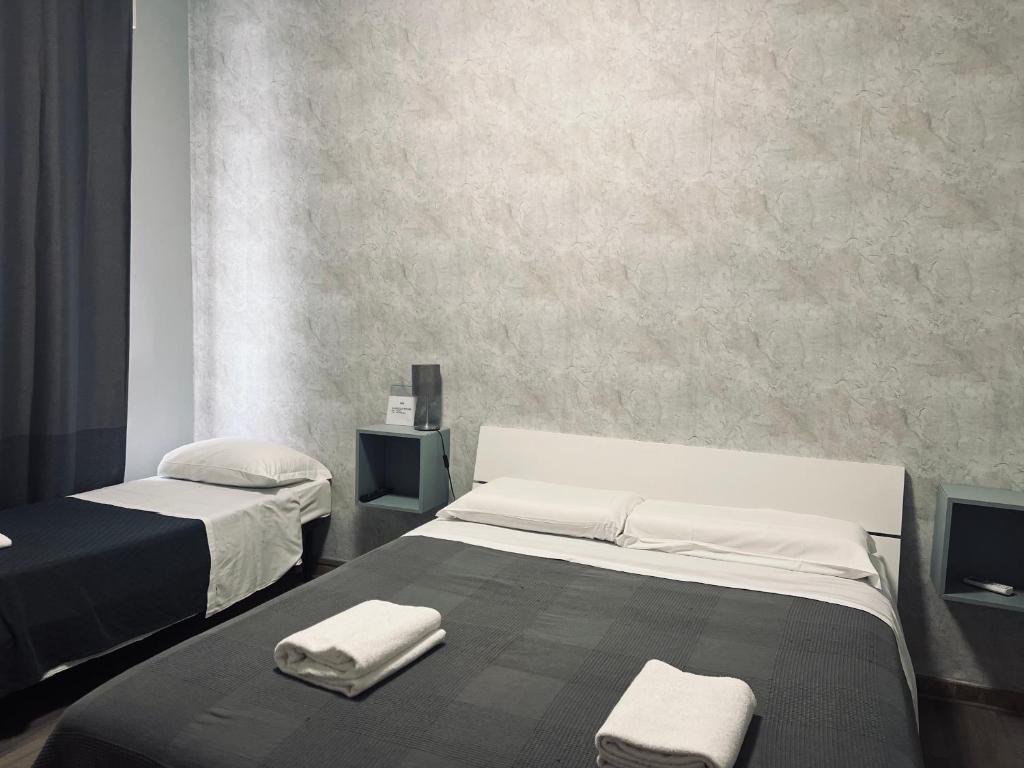Postel nebo postele na pokoji v ubytování Il Galileo Rooms