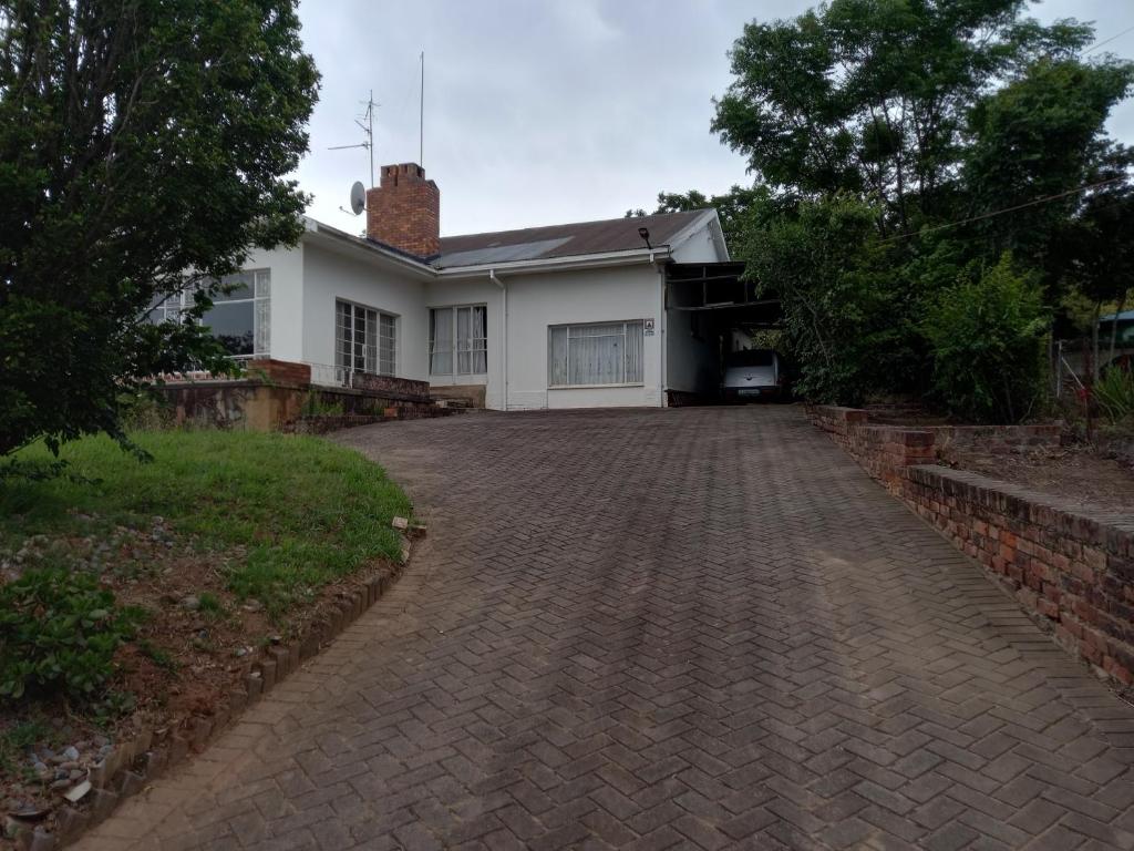 a house with a brick driveway in front of it at Vulindlela Mama Solutions in King Williams Town