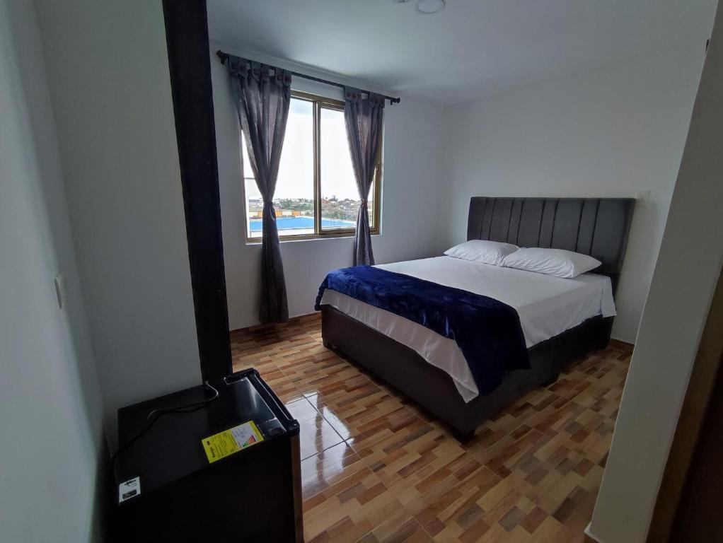 Postel nebo postele na pokoji v ubytování Apartahotel JDK
