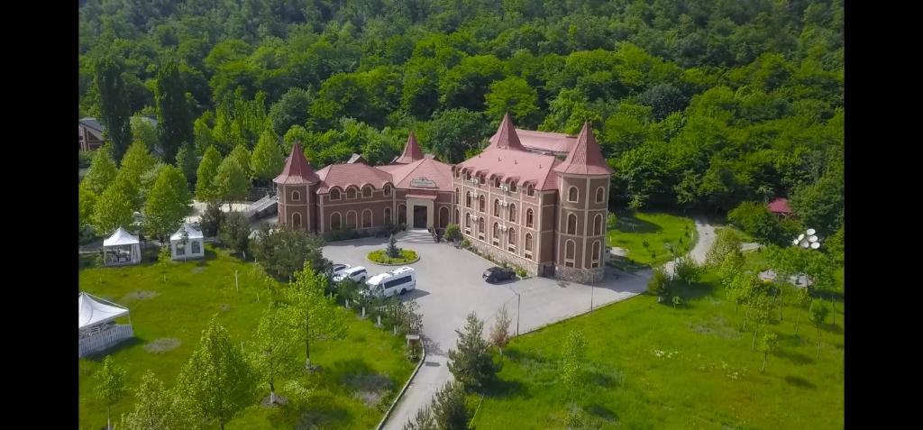 an aerial view of a large building with a yard at Chateau Qusar Hotel & Restaurant in Qusar