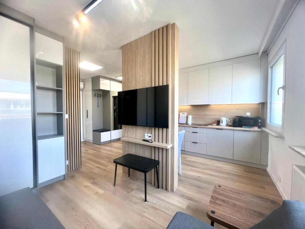 a living room with a large flat screen tv at Apartament Kolejowa in Olsztynek