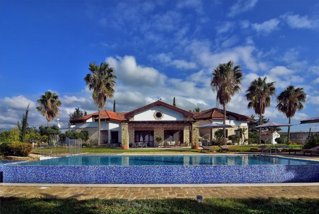 a house with a swimming pool in front of a house at Villa Margarita in Polis Chrysochous