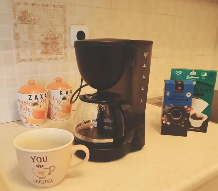a coffee maker and a coffee cup on a counter at Rosemary apartment in Eretria