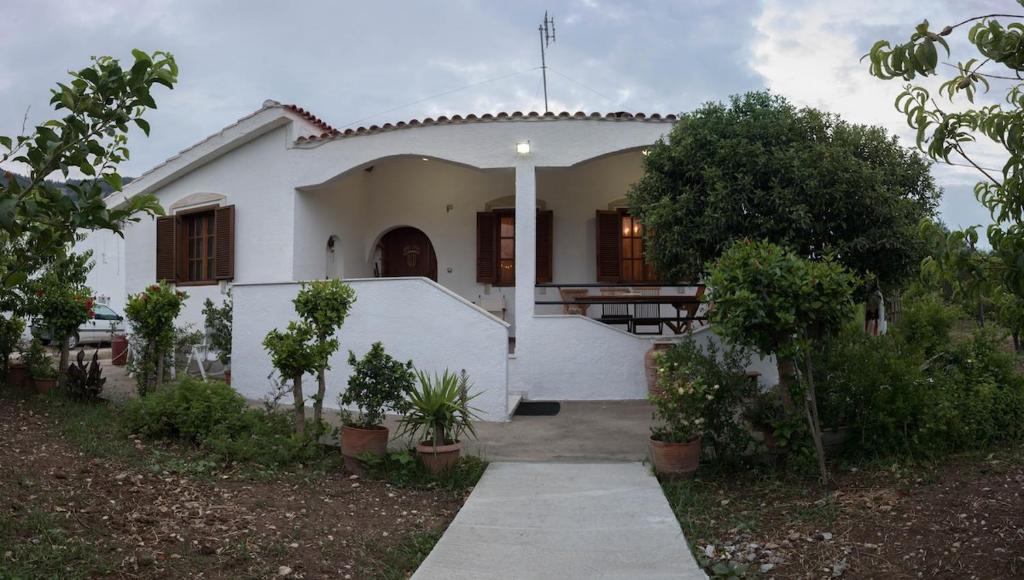 a white house with a pathway leading to it at Kolymbia home in Kolymbia