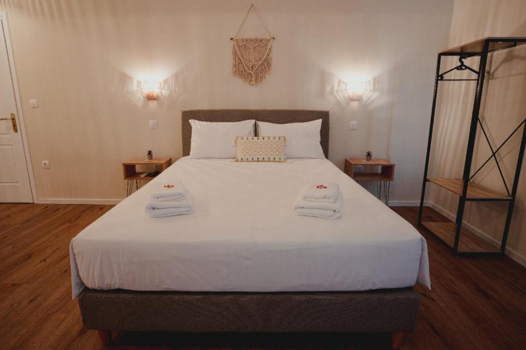 a bedroom with a large bed with towels on it at Andromeda 102 apartments in Spáta