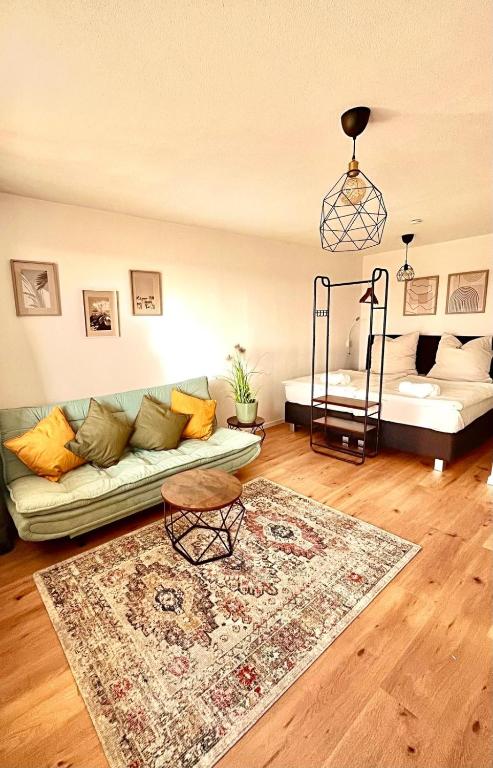 a living room with a couch and a rug at Schwarzwald Apartment in Löffingen
