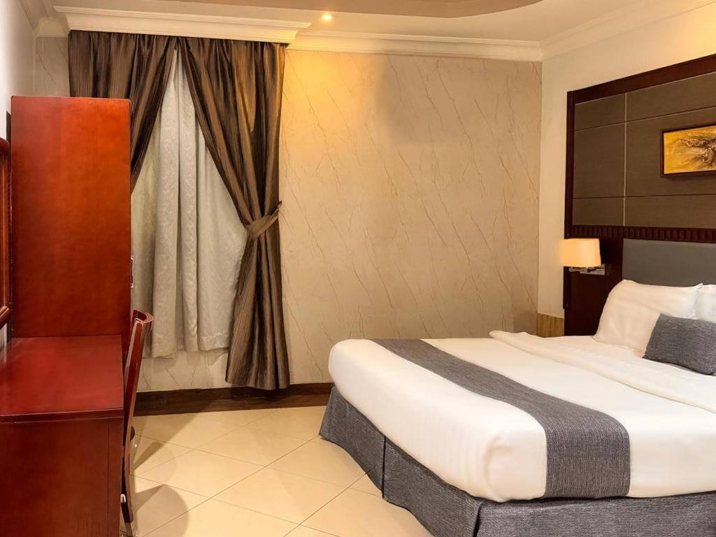 a hotel room with a bed and a window at Quiet Rooms 12 in Riyadh