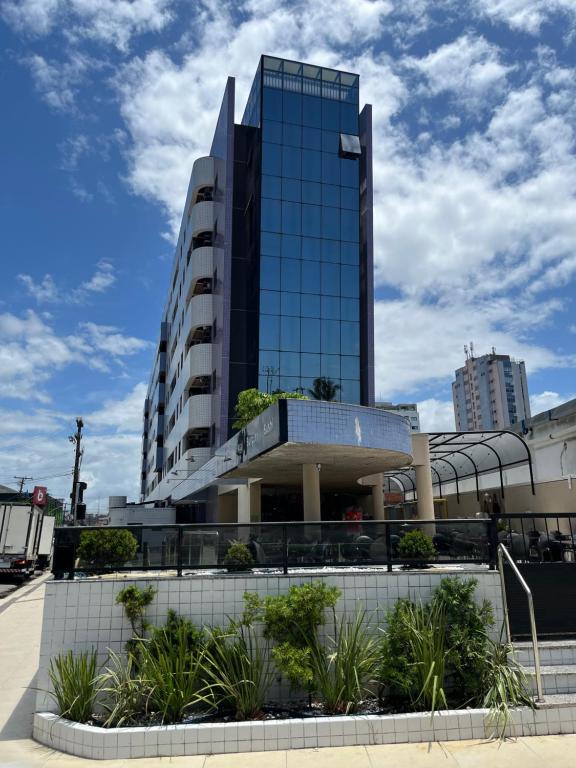 a building with a lot of plants in front of it at Residencial Neo 1 in Maceió