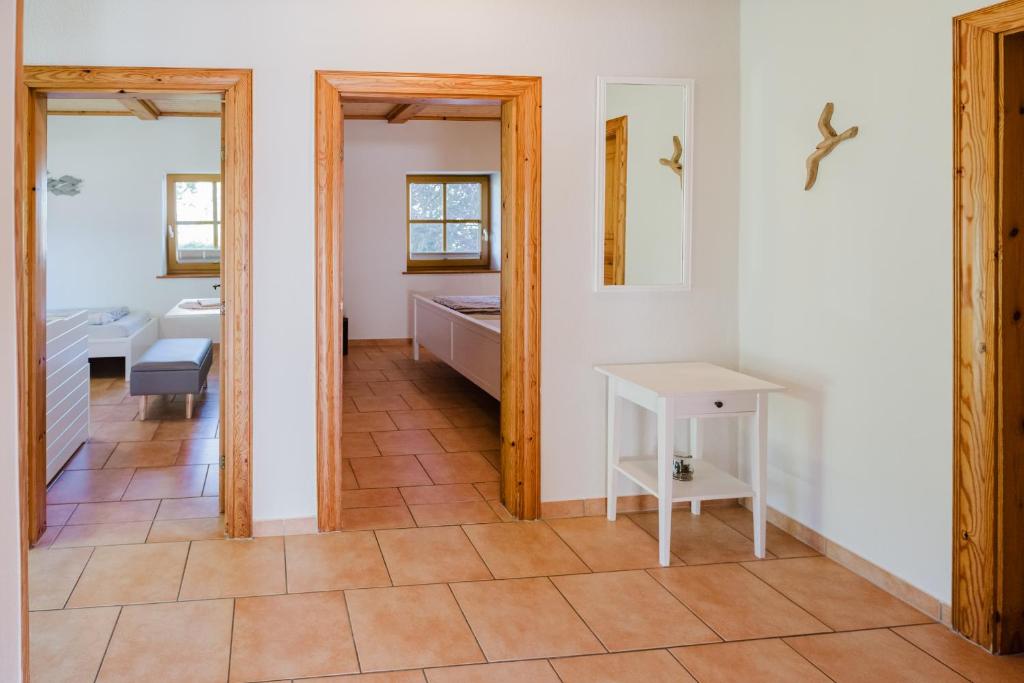 une chambre avec une salle de bain avec un lavabo et une table dans l'établissement Ferienwohnung Fachwerkhaus - Westen unten - Bauernhof Hopp Vadersdorf, à Fehmarn
