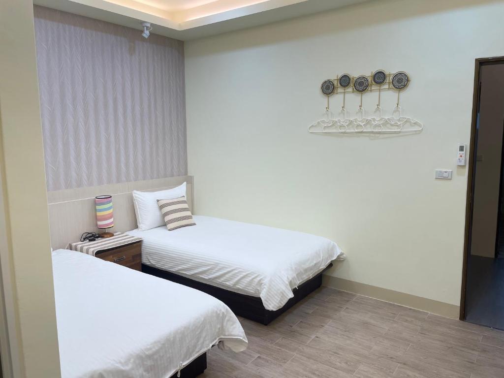 Postel nebo postele na pokoji v ubytování Yu Shou Hao Hsien Guesthouse