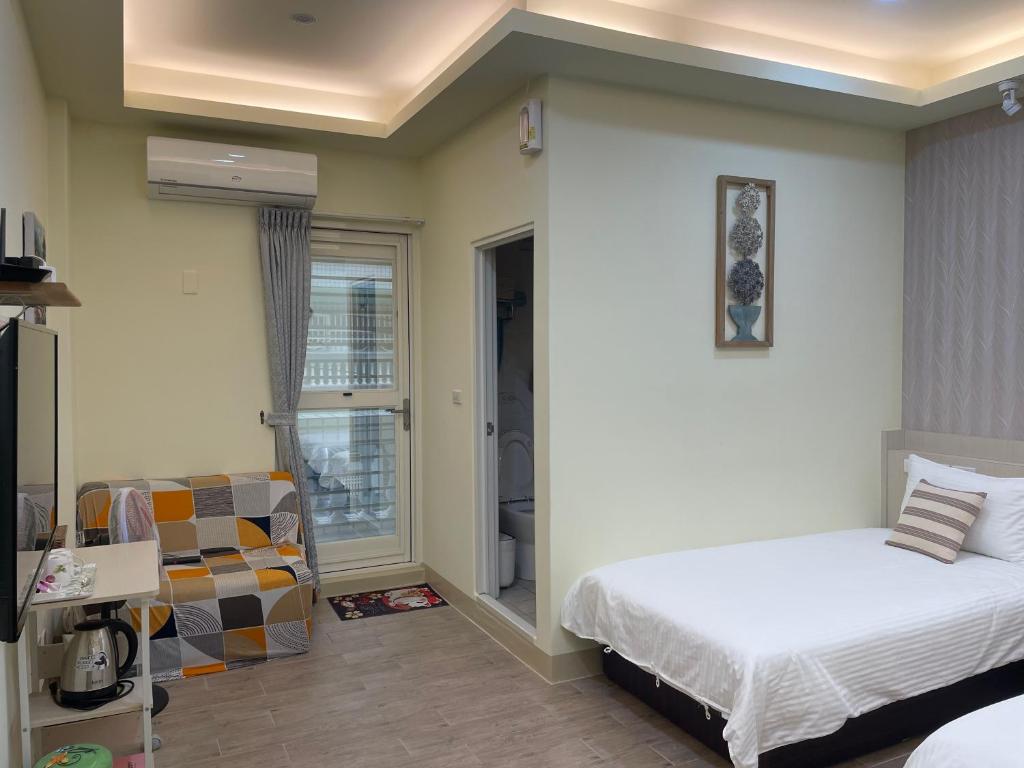 Postel nebo postele na pokoji v ubytování Yu Shou Hao Hsien Guesthouse
