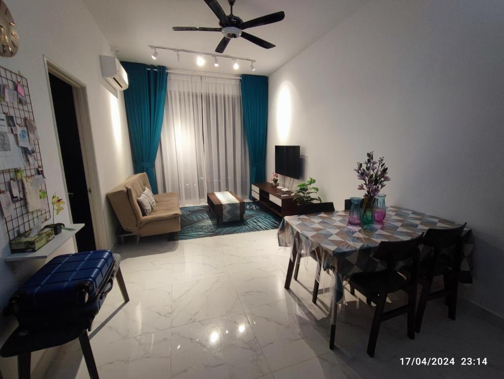 a living room with a dining room table and a couch at Troika Residence Studio, Kota Bharu by MYRAH in Kota Bharu