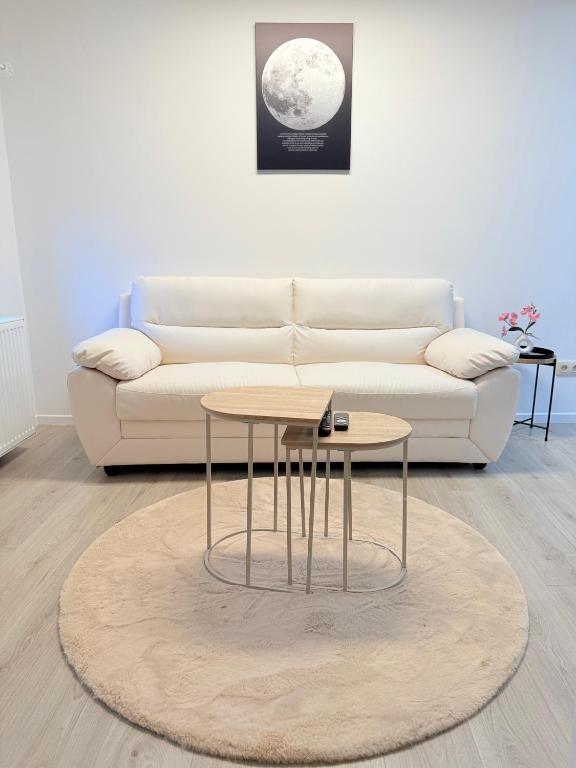 a living room with a couch and a coffee table at Suite 06 in Charleroi