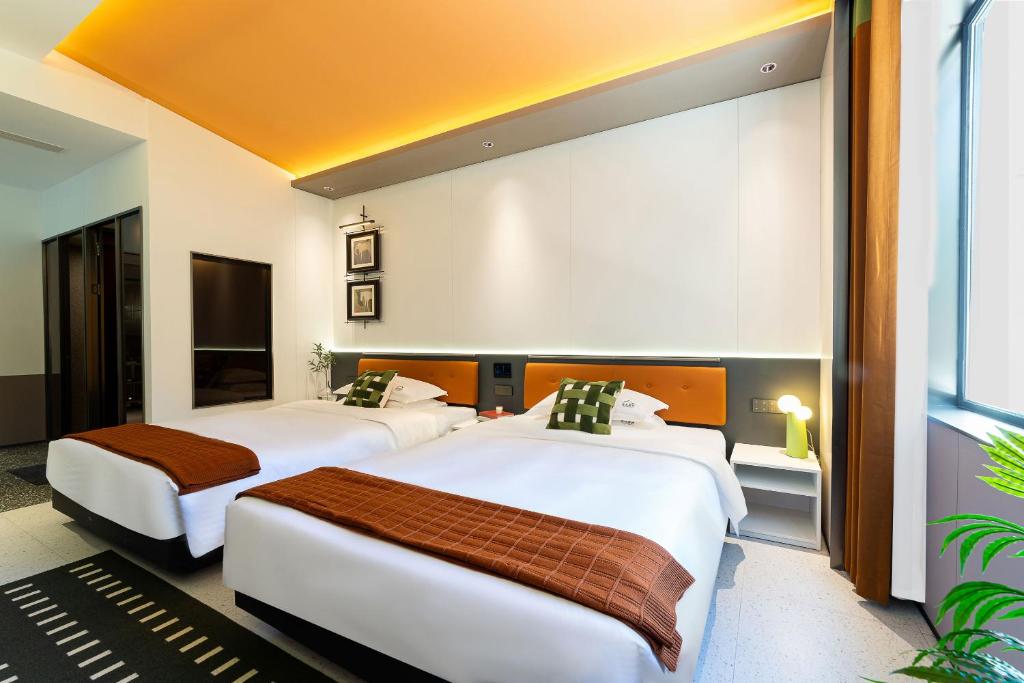 Postel nebo postele na pokoji v ubytování Vishan Keys Hotel 维尚潮宿