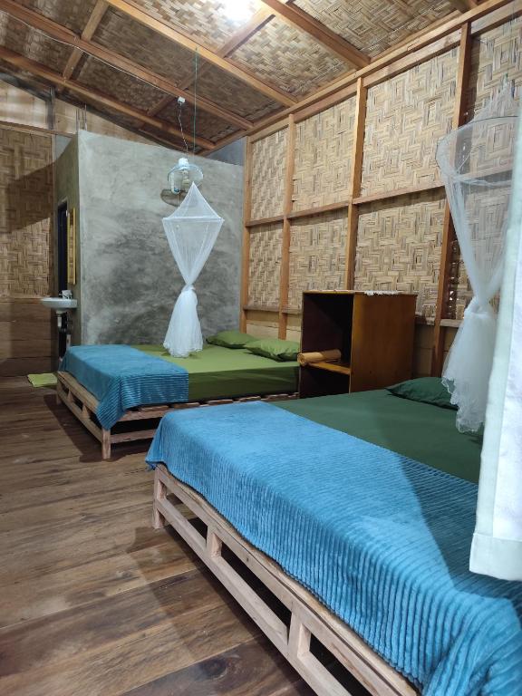 Postel nebo postele na pokoji v ubytování Bua Guesthouse Tangkahan