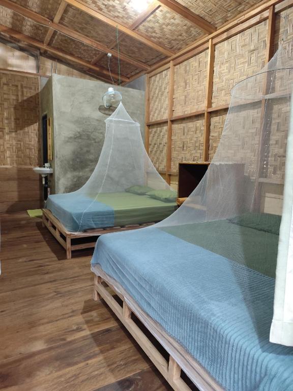 Postel nebo postele na pokoji v ubytování Bua Guesthouse Tangkahan