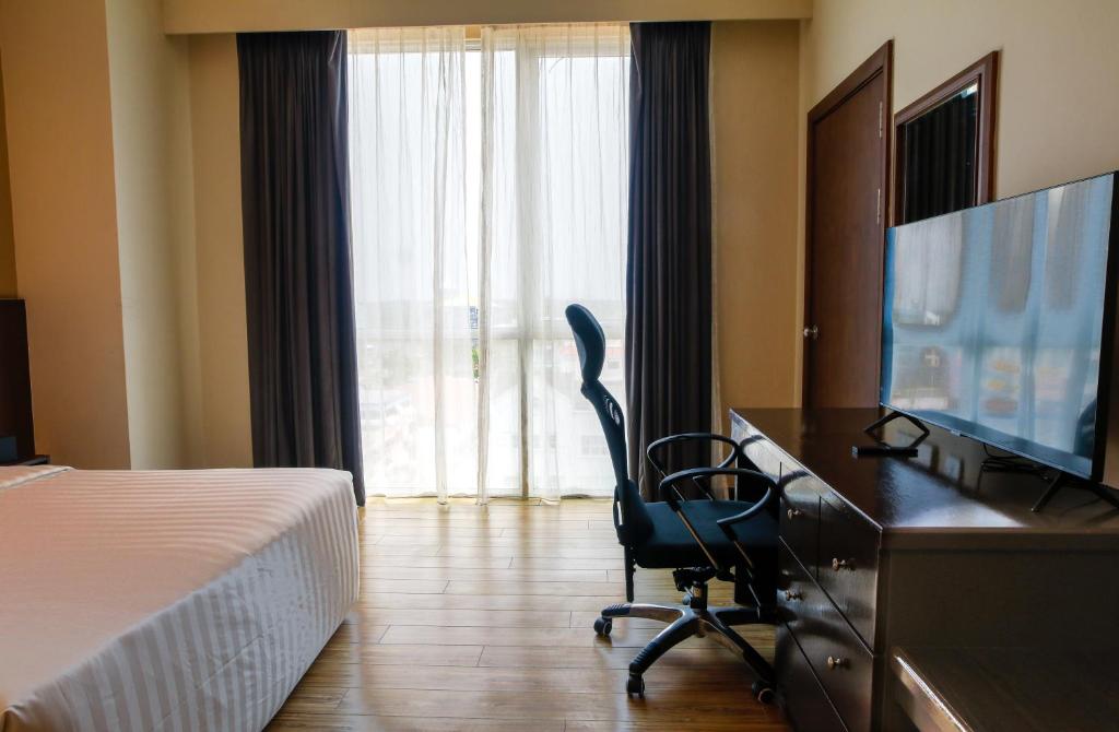 Телевизор и/или развлекательный центр в Swiss Hotel Apartment
