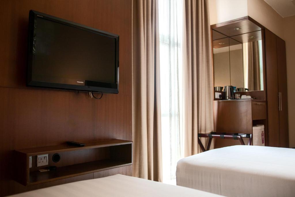 Телевизор и/или развлекательный центр в Swiss Hotel Apartment
