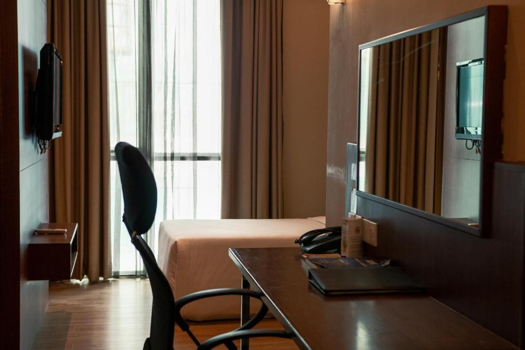 Телевизор и/или развлекательный центр в Swiss Hotel Apartment