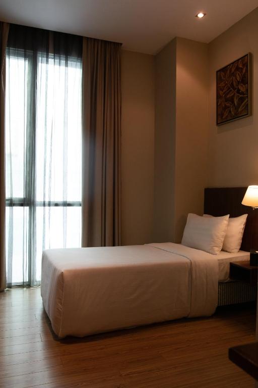 Кровать или кровати в номере Swiss Hotel Apartment