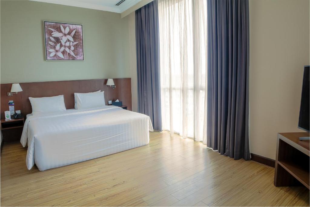 Кровать или кровати в номере Swiss Hotel Apartment