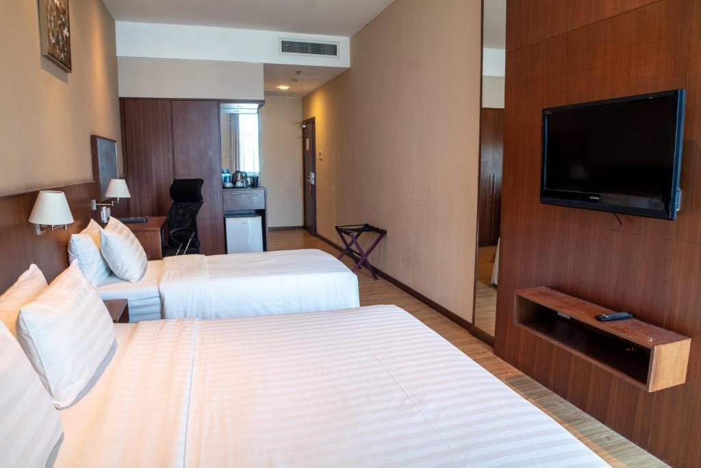 Телевизор и/или развлекательный центр в Swiss Hotel Apartment
