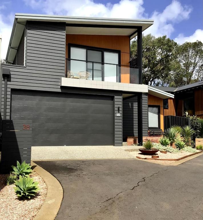 a house with a garage in front of it at Mojo's Lodge in Margaret River Town