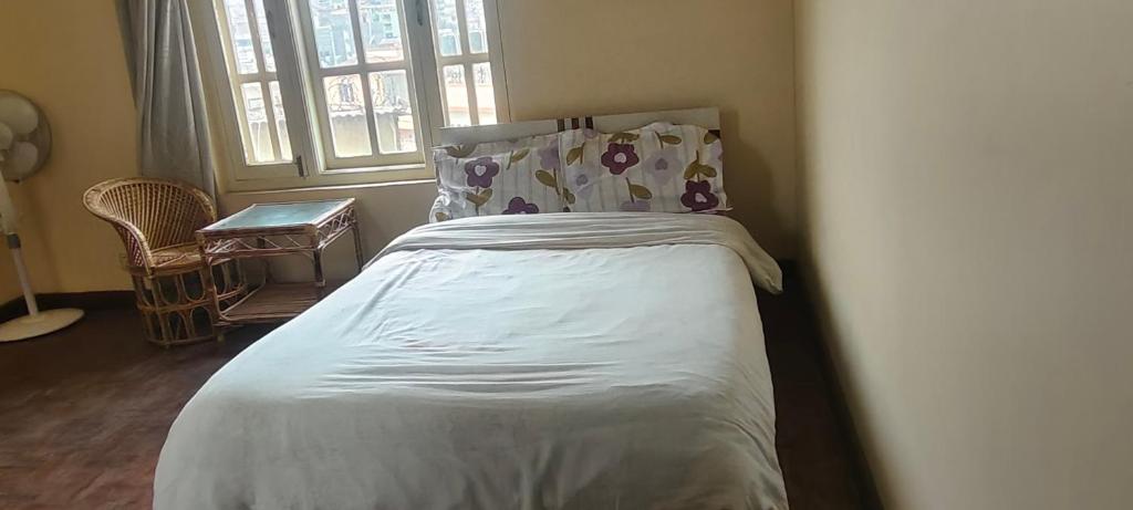 a bedroom with a bed and a window at Heritage View Homestay, Kathmandu in Kathmandu