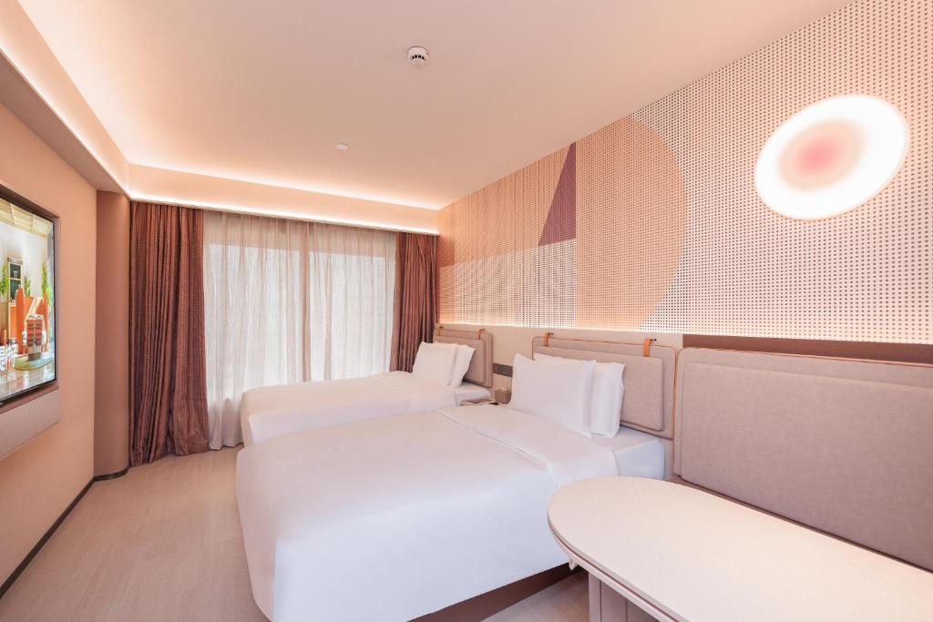 Postel nebo postele na pokoji v ubytování Orange Guangzhou Baiyun Airport Hotel