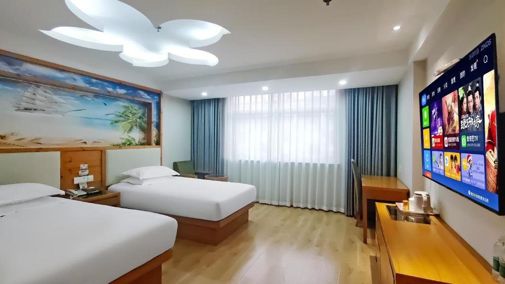 Postel nebo postele na pokoji v ubytování Yiwu Ruifeng Hotel